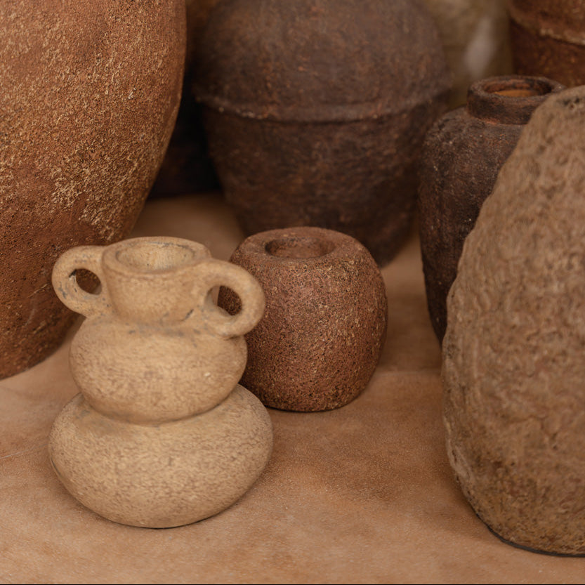 Collection of brown and beige pots on a textured surface