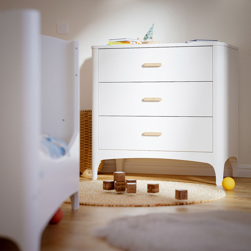 NEREE Chest of Drawers - Neige with wooden drawers in a room with toys on the floor