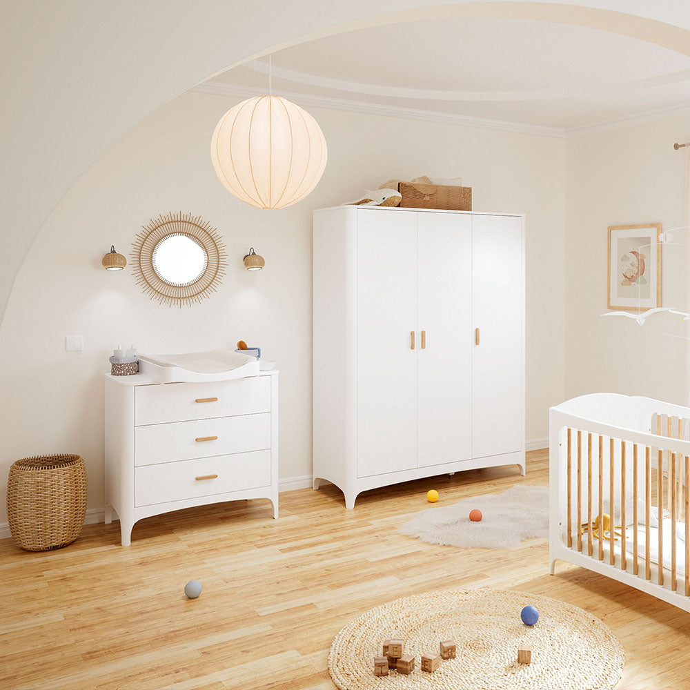 Nursery room with white furniture including a NEREE chest of drawers