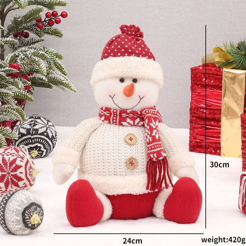 Bambole di Natale rosse sedute per la casa