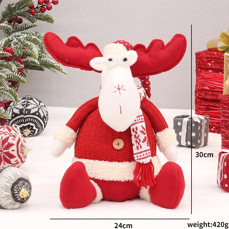 Bambole di Natale rosse sedute per la casa