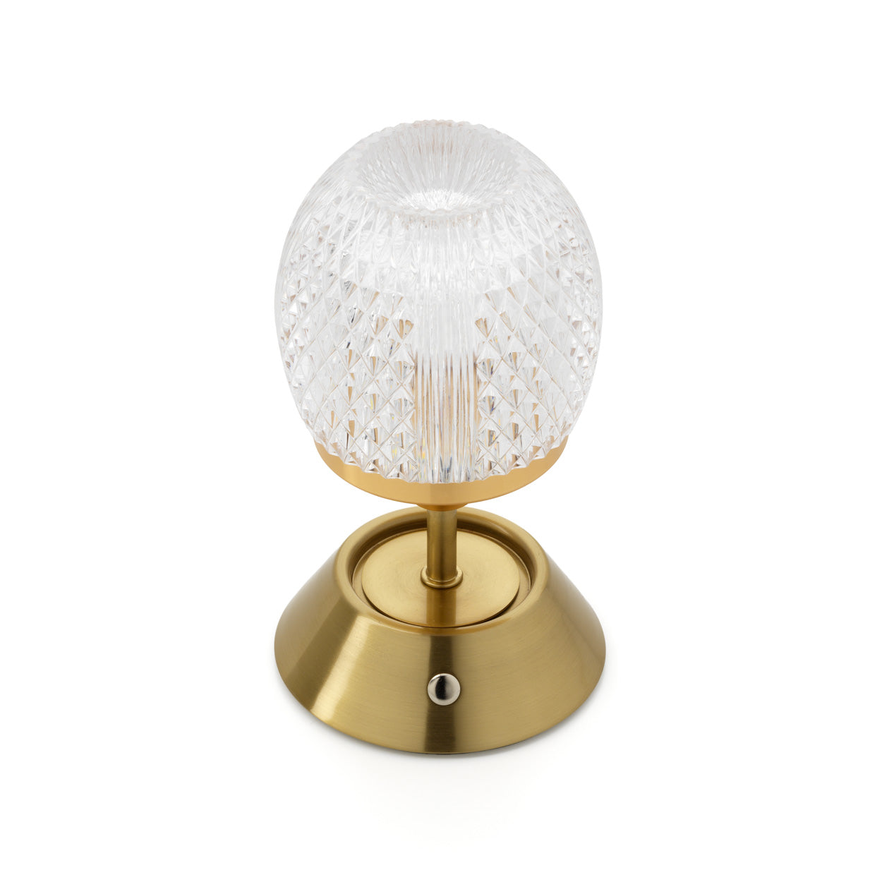 Decorative gold table lamp with textured glass shade on a white background