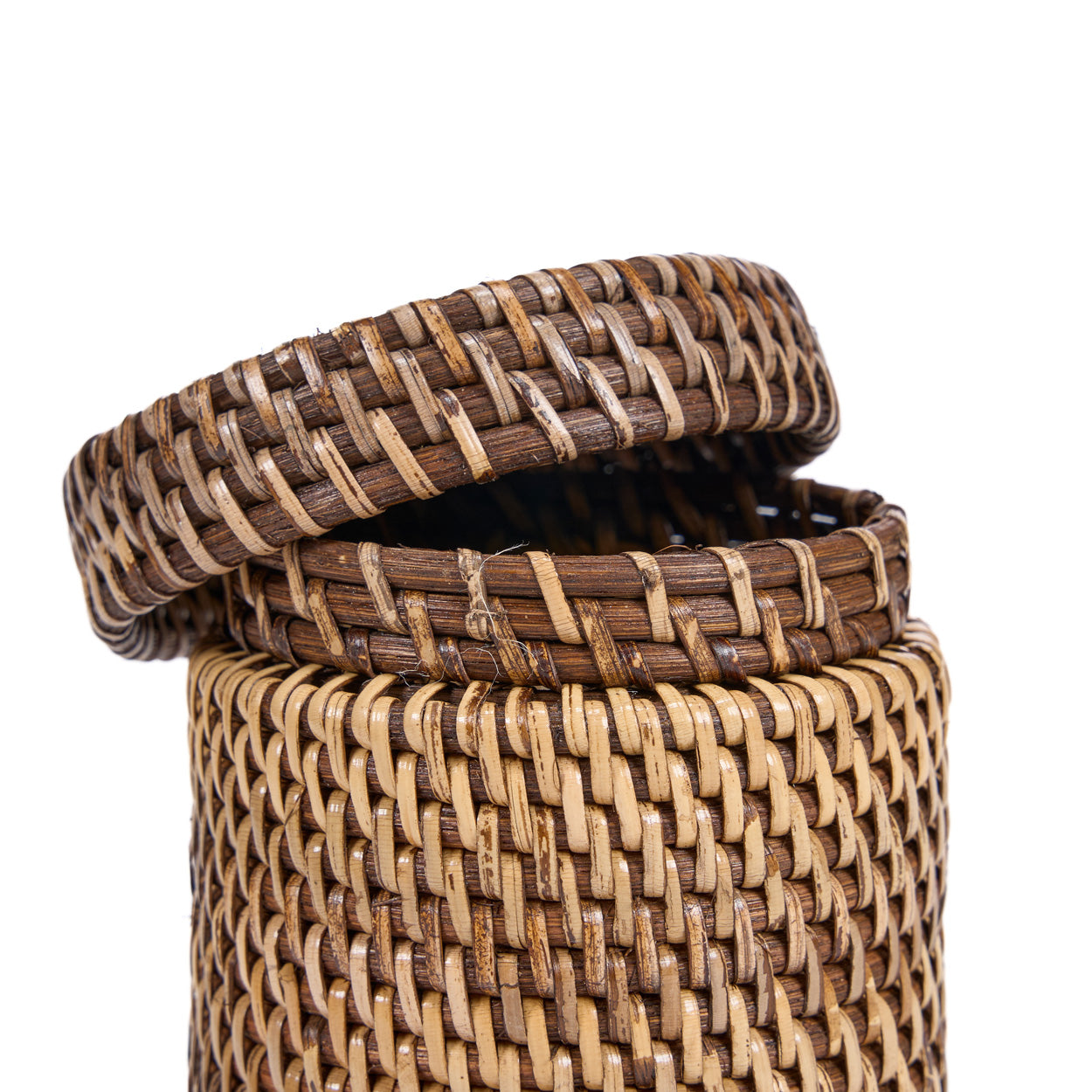 Opened woven rattan basket with lid on a white background