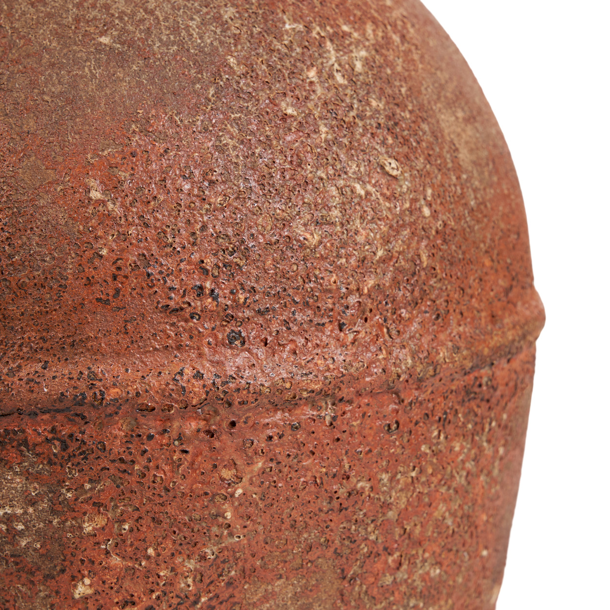 Close-up of a textured brown vase on a white background