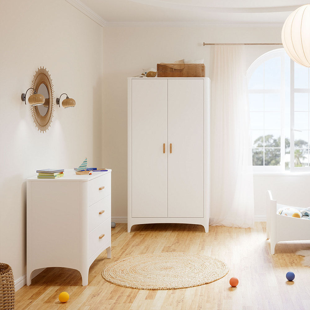 NEREE Chest of Drawers - Neige in a bright room with a window and decorative items.