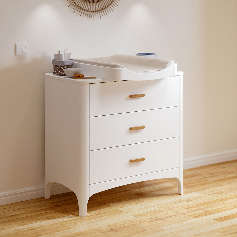 NEREE Chest of Drawers - Neige with wooden drawers in a room with beige walls and wooden floor.