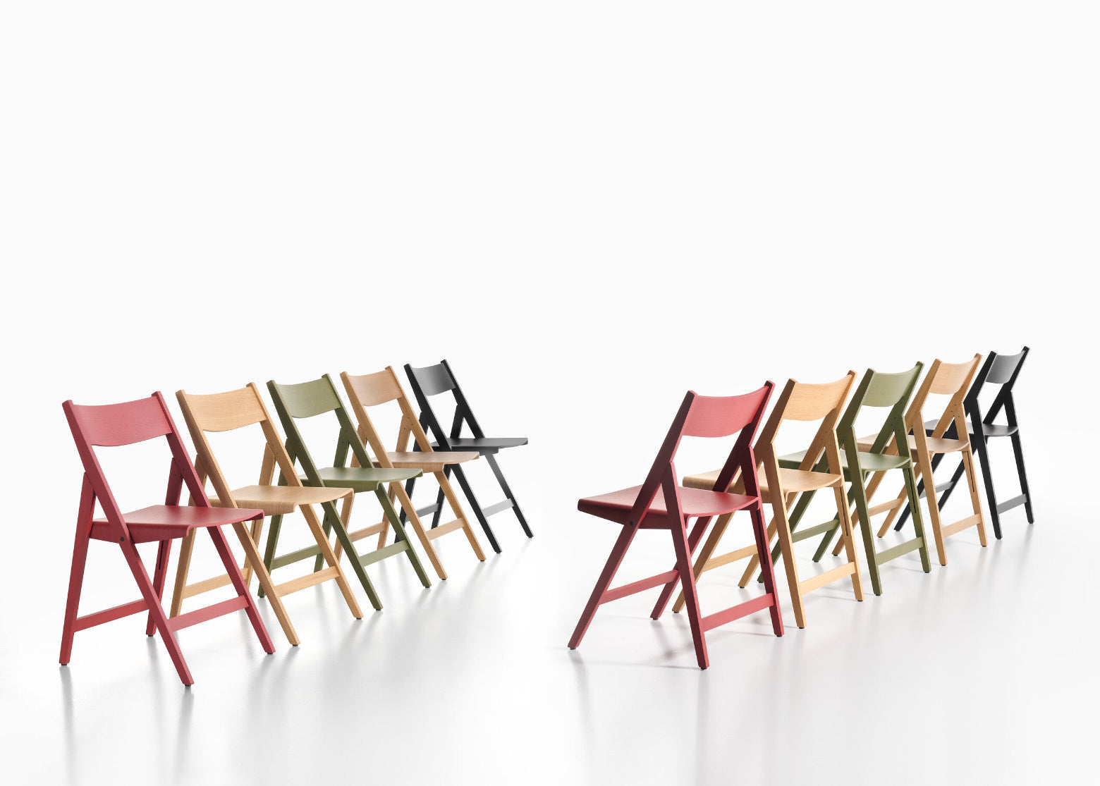 Set of colorful THEO folding chairs arranged in a row on a white background