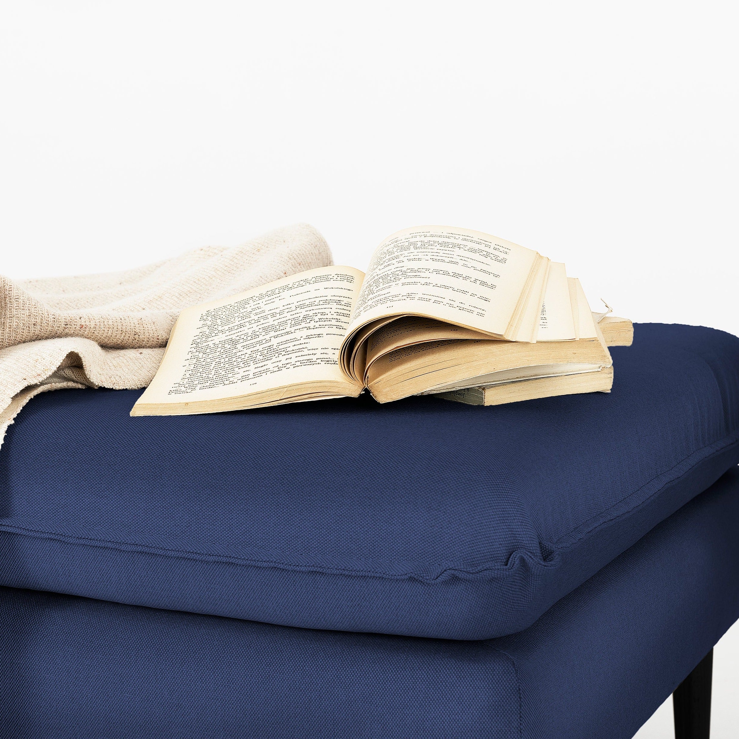 POSH Black Pouffe upholstery colour  blue interior view with a book